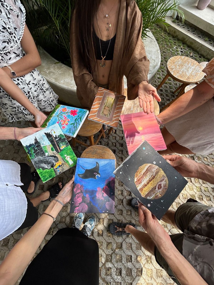 Close-up of painted canvases held by guests